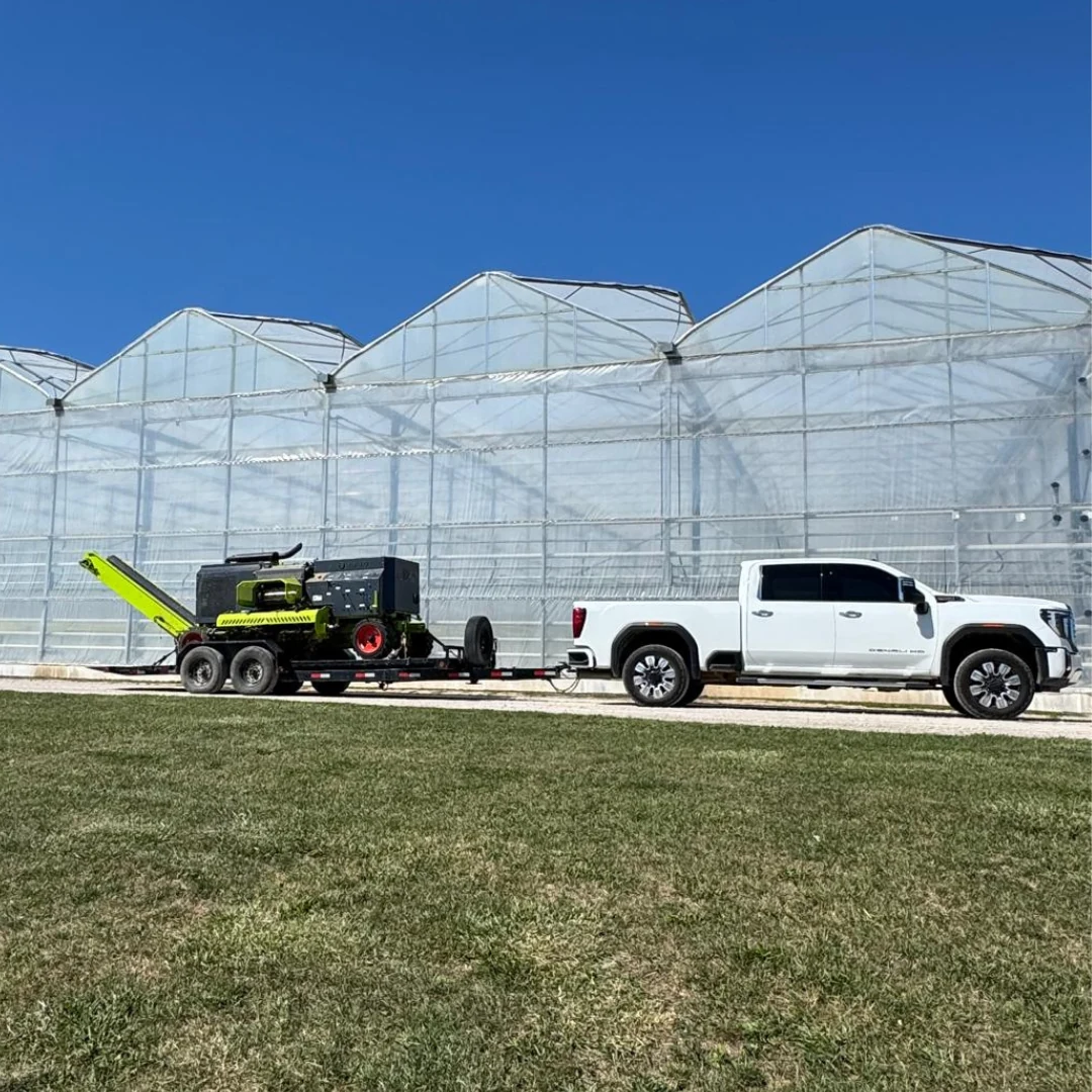 LGS shredder and truck in front of a greenhouse